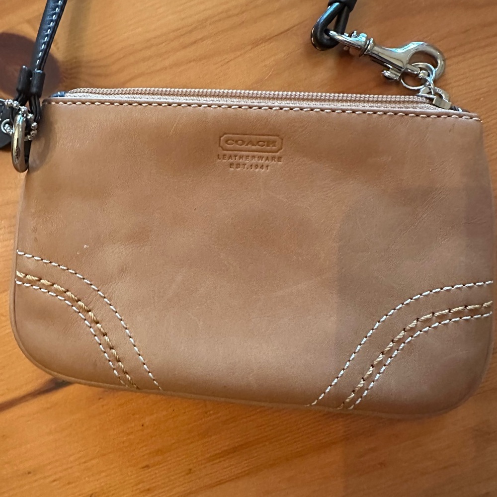 Tan Coach wristlet with brown handle, preowned.